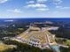 Aerial view of new construction in a developing community surrounded by ponds and lush green spaces at 280 Warner Crossing Way, Loris, SC 29569