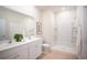 Well-lit bathroom with double vanity, white cabinets, and a shower-tub combination at 280 Warner Crossing Way, Loris, SC 29569