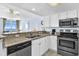 Modern kitchen with stainless steel appliances and a breakfast bar overlooking the ocean at 2801 S Ocean Blvd. # 733, North Myrtle Beach, SC 29582
