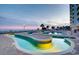 Outdoor pool with lazy river and lounge chairs at sunset at 2801 S Ocean Blvd. # 733, North Myrtle Beach, SC 29582
