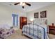 Comfortable bedroom with ceiling fan, floral accent chair, and doorway to other rooms at 300 Nuthatch Ln. # A, Murrells Inlet, SC 29576