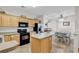 Bright kitchen with stainless steel appliances, tiled floors, oak cabinets and a center island at 300 Nuthatch Ln. # A, Murrells Inlet, SC 29576