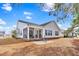 Spacious backyard view featuring a sunroom, patio, and lush landscaping at 3124 Ivy Lea Dr., Conway, SC 29526