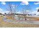 Curved walking path along a serene community pond with mature trees and a fountain feature at 3124 Ivy Lea Dr., Conway, SC 29526