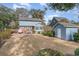 Backyard view of a blue two-story home with a shed and mature trees at 317 14Th Ave. N, Surfside Beach, SC 29575