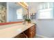 Bathroom vanity with a large mirror, a white sink, and wood cabinets at 317 14Th Ave. N, Surfside Beach, SC 29575