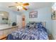 Cozy bedroom with blue patterned bedding, complemented by wooden floors, a wicker accent, and blue walls at 317 14Th Ave. N, Surfside Beach, SC 29575