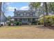 Charming two-story home featuring a welcoming wrap-around porch, blue siding, and a well-manicured front lawn at 317 14Th Ave. N, Surfside Beach, SC 29575