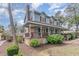 Charming two-story blue home featuring a cozy front porch and manicured landscaping at 317 14Th Ave. N, Surfside Beach, SC 29575