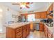 Charming kitchen featuring wood cabinetry, stainless steel appliances, and a functional center island at 317 14Th Ave. N, Surfside Beach, SC 29575