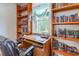 Home office with built in shelving, filled with books, and a desk by the window at 317 14Th Ave. N, Surfside Beach, SC 29575