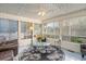 Bright sunroom filled with natural light, featuring a ceiling fan, tile floors and comfortable seating at 317 14Th Ave. N, Surfside Beach, SC 29575