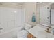 Clean bathroom with a shower-tub combo, light wood vanity, and white tile at 3524 Crepe Myrtle Ct. # 3524, Myrtle Beach, SC 29577