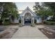 Inviting clubhouse entrance with manicured landscaping and charming architectural details at 3524 Crepe Myrtle Ct. # 3524, Myrtle Beach, SC 29577