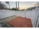 A secluded patio with gray and red pavers, enclosed by a pristine white fence, offering outdoor enjoyment at 3524 Crepe Myrtle Ct. # 3524, Myrtle Beach, SC 29577