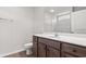 Bathroom with dark wood vanity, white countertop and sink, a large mirror, and a shower/tub combination at 375 West Dogwood Rd., Loris, SC 29569