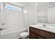 Bathroom featuring a white shower/tub combination, white countertop and dark wood vanity, and wood-look flooring at 375 West Dogwood Rd., Loris, SC 29569