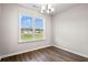 Well-lit dining room featuring hardwood floors, a modern chandelier, and large window with neighborhood view at 375 West Dogwood Rd., Loris, SC 29569