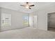 Bright main bedroom featuring a ceiling fan, soft carpet, and walk-in closet at 379 West Dogwood Rd., Loris, SC 29569