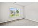 Sunlit empty bedroom with neutral walls, carpet flooring, and a large window with a view at 379 West Dogwood Rd., Loris, SC 29569