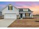 Charming new construction home features a two-car garage, blue shutters, and manicured front lawn at 379 West Dogwood Rd., Loris, SC 29569