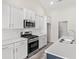 Modern kitchen boasts stainless steel appliances, white cabinets, and quartz countertops at 379 West Dogwood Rd., Loris, SC 29569