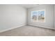 Bright bedroom with neutral carpet, window view, and light gray walls at 383 West Dogwood Rd., Loris, SC 29569