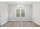 Dining room featuring hardwood floors, white walls, ceiling chandelier, and a large window at 383 West Dogwood Rd., Loris, SC 29569