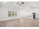 Bright, open-concept living space with hardwood floors, a vaulted ceiling, and large windows at 383 West Dogwood Rd., Loris, SC 29569