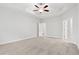 Spacious primary bedroom featuring carpeted floors, ceiling fan, and bathroom access at 383 West Dogwood Rd., Loris, SC 29569