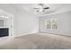 Bright main bedroom features carpeted floors, a ceiling fan, and bathroom access at 383 West Dogwood Rd., Loris, SC 29569