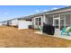 This cozy backyard features a grill, outdoor seating, and a screened-in porch for relaxing at 4027 Taranto Loop # 3203-C, Myrtle Beach, SC 29579