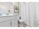 Bright bathroom featuring a vanity with storage, a toilet, and a shower with a white curtain at 4027 Taranto Loop # 3203-C, Myrtle Beach, SC 29579