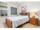 Cozy bedroom with a wooden bed frame, decorative wall art, and natural light from the window at 4027 Taranto Loop # 3203-C, Myrtle Beach, SC 29579