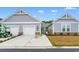 Light gray townhome with white garage doors and manicured landscaping at 4027 Taranto Loop # 3203-C, Myrtle Beach, SC 29579