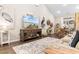 Bright living room with a TV, coastal artwork, a decorative rug, wood flooring, and adjacent dining area at 4027 Taranto Loop # 3203-C, Myrtle Beach, SC 29579