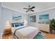 Staged bedroom with blue accents, a large bed, and coastal-themed decorations at 407 76Th Ave. N # C, Myrtle Beach, SC 29572