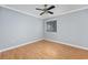 Bright bedroom with neutral walls, light-colored wood floors, and a window with blinds at 407 76Th Ave. N # C, Myrtle Beach, SC 29572