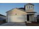 Two-story home featuring a one car garage and light beige siding at 444 Ribbon Rail Way, Loris, SC 29569