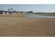 A serene view of the community, featuring a lake and a row of houses at 444 Ribbon Rail Way, Loris, SC 29569