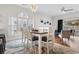 Bright dining room with natural light, a modern chandelier, and views of the backyard at 4655 Wild Iris Dr. # 101, Myrtle Beach, SC 29577