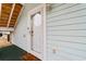 Close-up of a unit's front door with glass panel, light blue siding, a welcome mat, and a view of stairs at 4655 Wild Iris Dr. # 101, Myrtle Beach, SC 29577