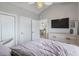 This bedroom boasts neutral walls, a ceiling fan, and a television mounted above a dresser at 4870 Dahlia Ct. # 304, Myrtle Beach, SC 29577