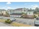 Exterior view of a condo building with garages and parking at 4870 Dahlia Ct. # 304, Myrtle Beach, SC 29577