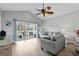 Comfortable living room featuring vaulted ceiling, ceiling fan, and access to the outdoor deck at 4870 Dahlia Ct. # 304, Myrtle Beach, SC 29577