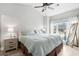 Serene main bedroom with hardwood floors, a comfortable bed, and natural light from a large window at 4870 Dahlia Ct. # 304, Myrtle Beach, SC 29577