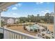 Pool area with palm trees, lounge chairs, a grill, and a pool house at 4870 Dahlia Ct. # 304, Myrtle Beach, SC 29577