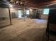 Unfinished basement with concrete floor, shelving, and exposed ceiling beams offering potential for customization at 51 Cleburn St., Georgetown, SC 29440