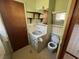 Classic bathroom with a vintage sink, toilet, and tiled walls at 51 Cleburn St., Georgetown, SC 29440