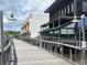 Waterfront boardwalk lined with businesses featuring weathered wooden planks and metal railings at 51 Cleburn St., Georgetown, SC 29440